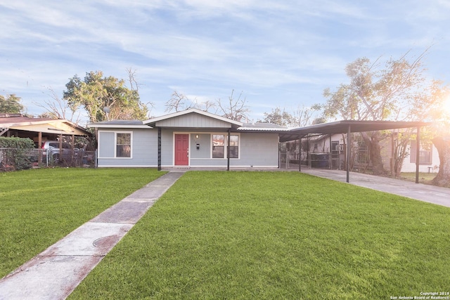 view of front facade with a front yard and a carport