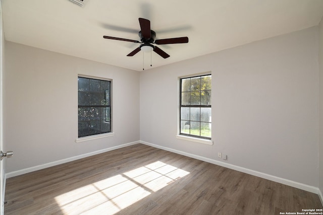 empty room featuring hardwood / wood-style flooring and ceiling fan