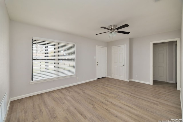 empty room featuring ceiling fan and light wood-type flooring