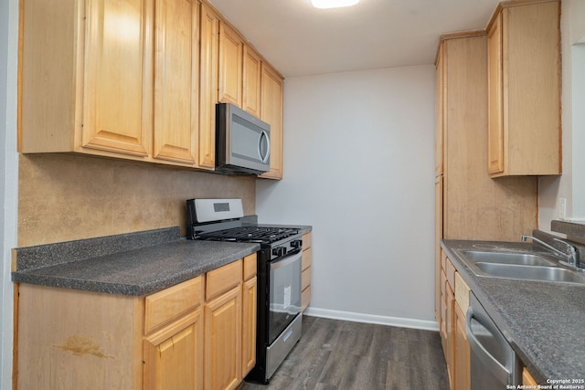 kitchen with light brown cabinets, stainless steel appliances, dark wood-type flooring, and sink