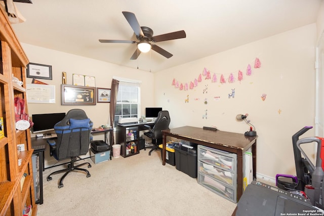 carpeted office featuring ceiling fan