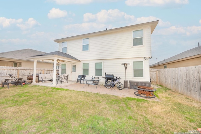 back of property featuring a yard, a patio, and an outdoor living space with a fire pit