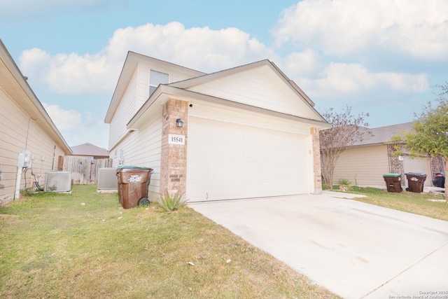 view of home's exterior featuring a garage, a lawn, and central air condition unit