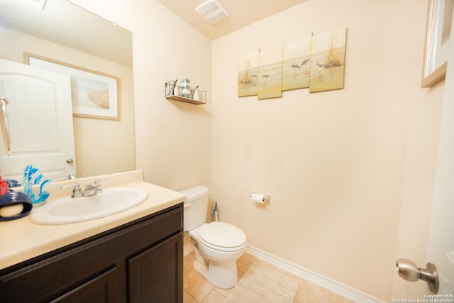 bathroom featuring tile patterned flooring, vanity, and toilet