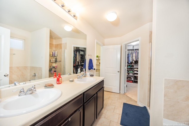 bathroom with tile patterned floors, vanity, and walk in shower