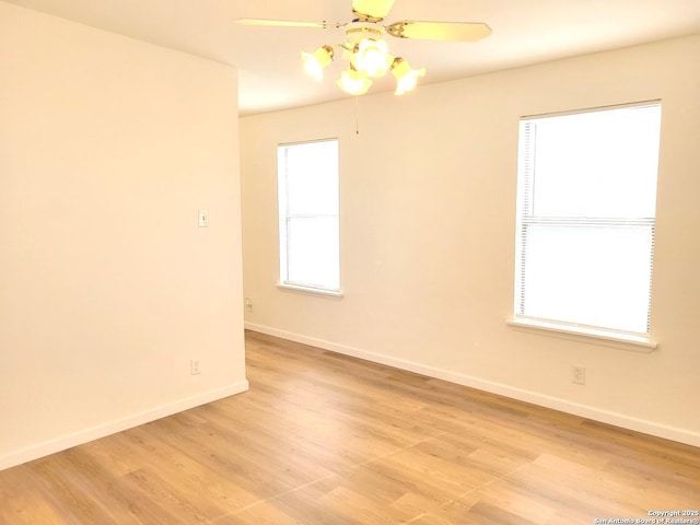 spare room featuring light hardwood / wood-style flooring, plenty of natural light, and ceiling fan