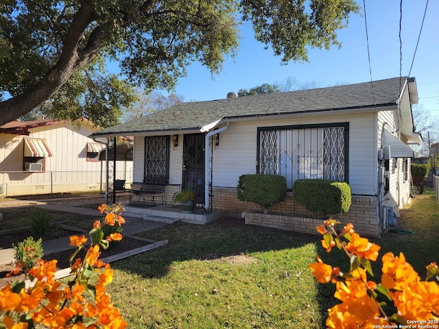 bungalow with covered porch and a front yard