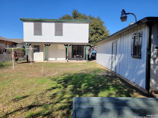 rear view of house with a yard and a patio area