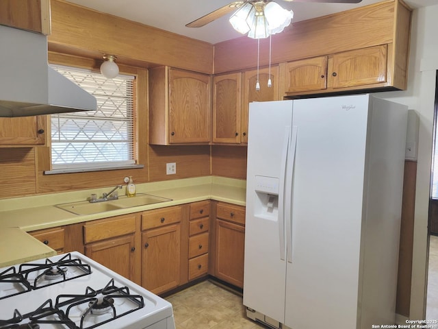 kitchen featuring ceiling fan, white appliances, sink, and range hood