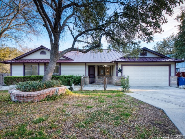 ranch-style home featuring covered porch and a garage