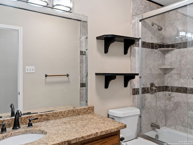 full bathroom featuring vanity, toilet, and combined bath / shower with glass door