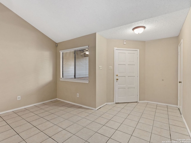 tiled foyer with a textured ceiling