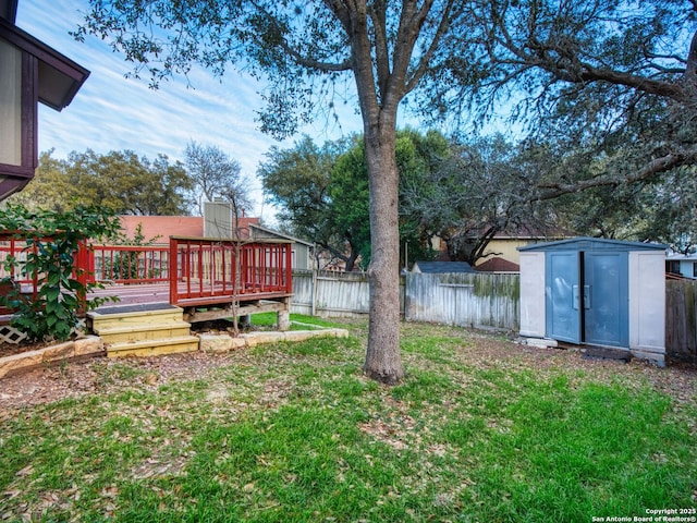 view of yard featuring a storage shed and a deck