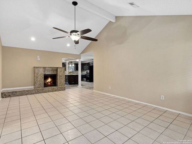 unfurnished living room featuring light tile patterned floors, lofted ceiling with beams, ceiling fan, and a premium fireplace