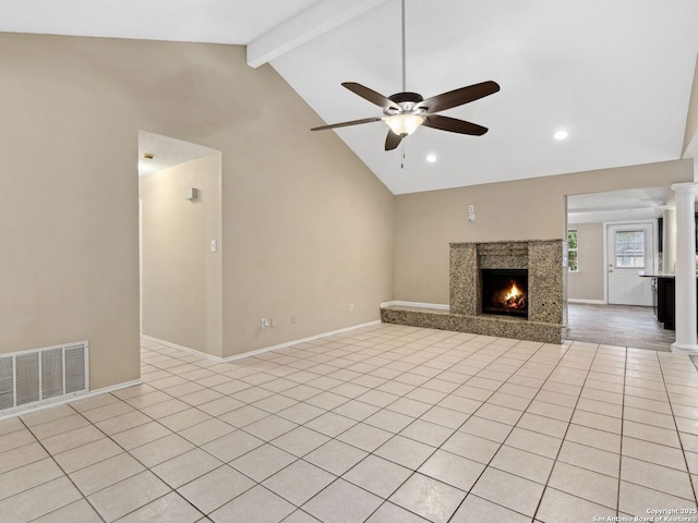 unfurnished living room with ceiling fan, beamed ceiling, high vaulted ceiling, a fireplace, and light tile patterned floors