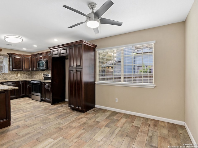 kitchen with dark brown cabinetry, tasteful backsplash, light stone counters, light hardwood / wood-style flooring, and appliances with stainless steel finishes