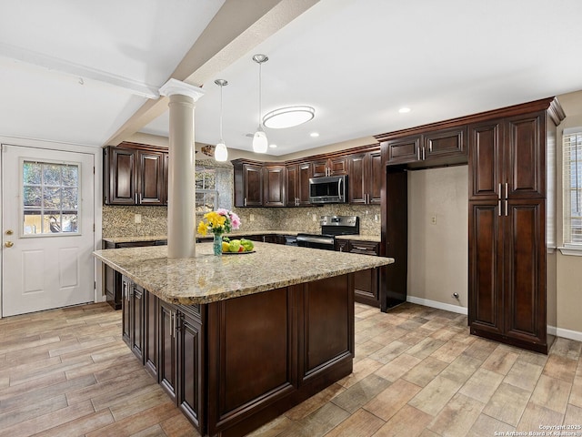 kitchen with a center island, hanging light fixtures, ornate columns, dark brown cabinets, and stainless steel appliances