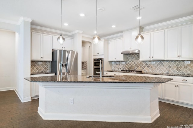 kitchen with a center island with sink, white cabinets, decorative light fixtures, and appliances with stainless steel finishes