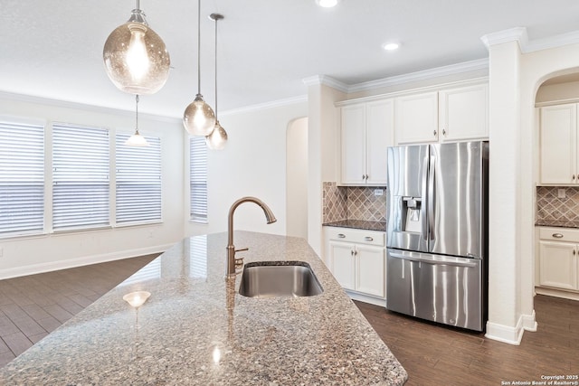 kitchen featuring stainless steel fridge with ice dispenser, white cabinets, and dark stone counters