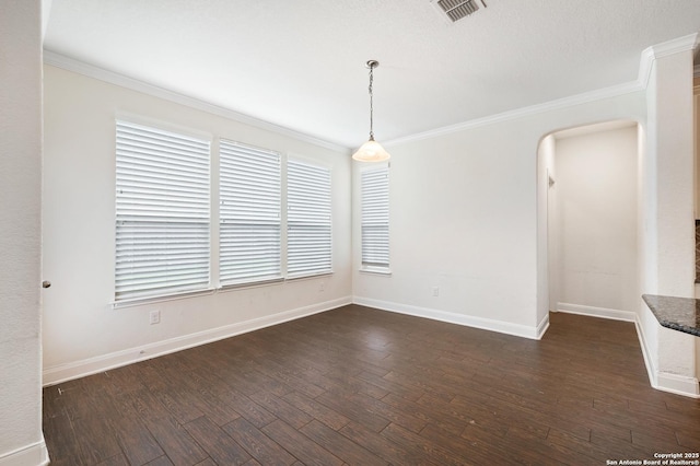 spare room with crown molding and dark wood-type flooring