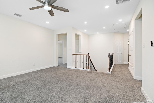 carpeted spare room featuring ceiling fan