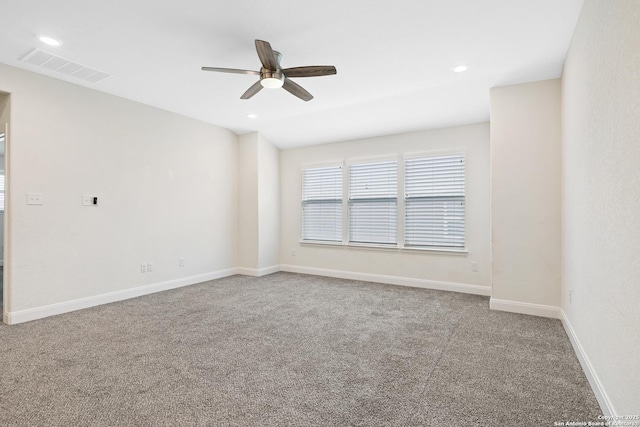 spare room with carpet and ceiling fan