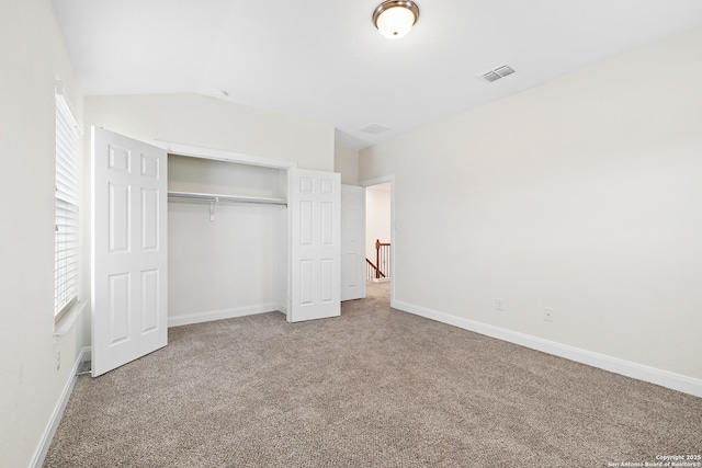 unfurnished bedroom featuring carpet and a closet