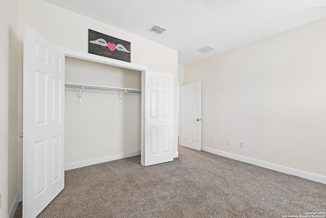 unfurnished bedroom with carpet floors and a closet