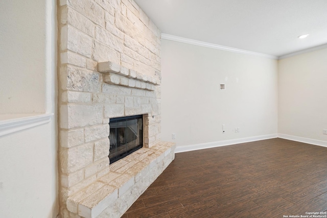 unfurnished living room with dark hardwood / wood-style flooring, a stone fireplace, and crown molding