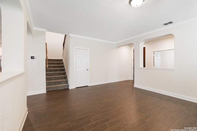 unfurnished living room featuring dark hardwood / wood-style floors and ornamental molding