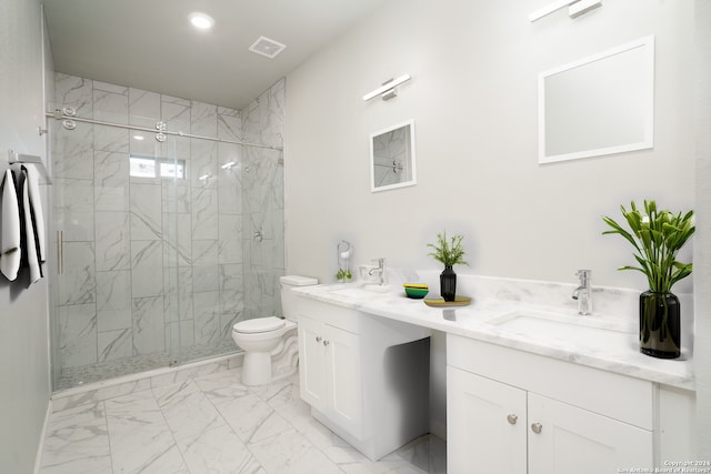 bathroom with vanity, toilet, and a shower with shower door