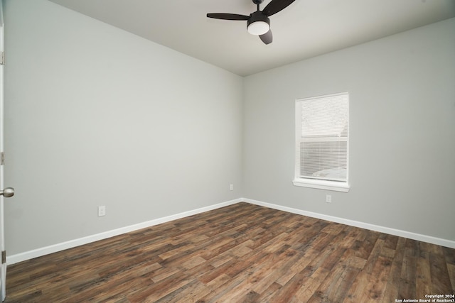 unfurnished room featuring ceiling fan and dark wood-type flooring