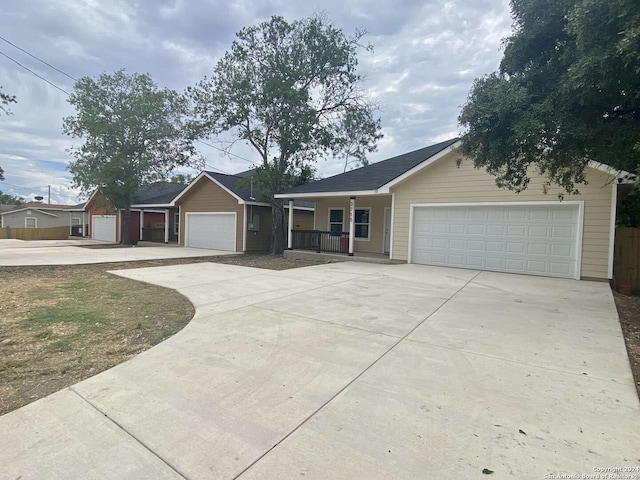 single story home featuring a porch and a garage