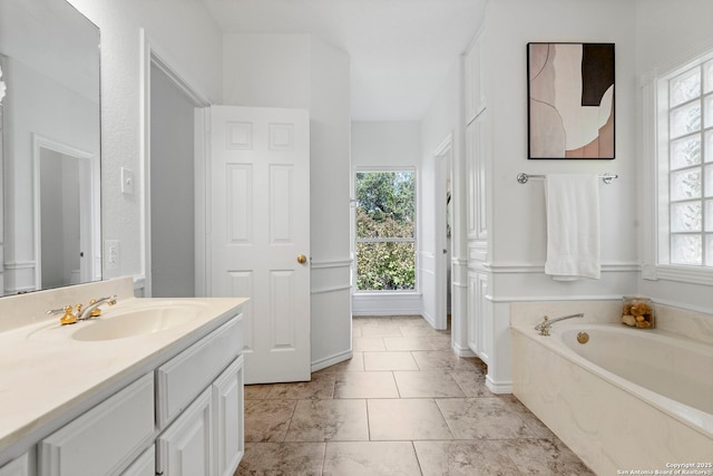 bathroom featuring tile patterned floors, a bathtub, and vanity