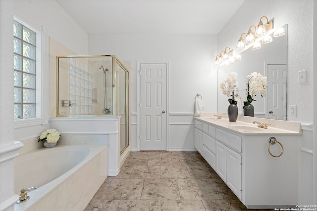 bathroom with vanity and independent shower and bath