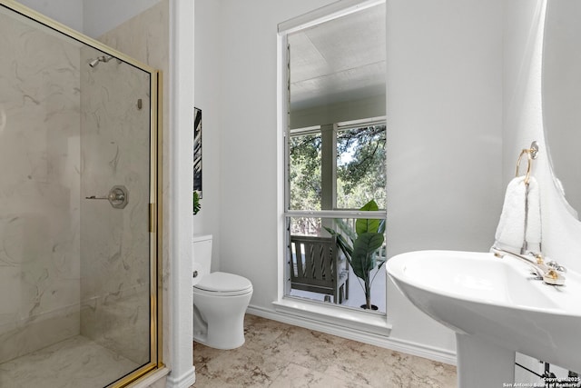 bathroom featuring toilet, walk in shower, and sink