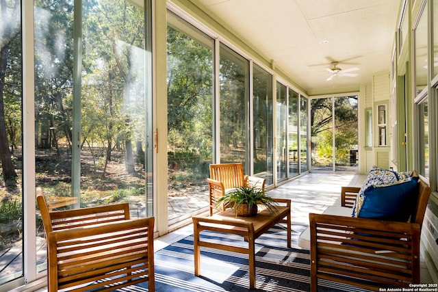 sunroom featuring ceiling fan