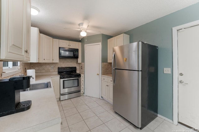 kitchen featuring ceiling fan, light tile patterned floors, a textured ceiling, tasteful backsplash, and stainless steel appliances