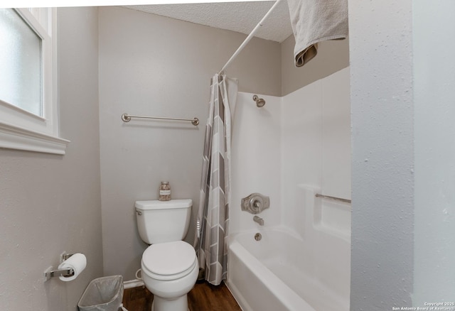 bathroom featuring wood-type flooring, a textured ceiling, toilet, and shower / bath combo