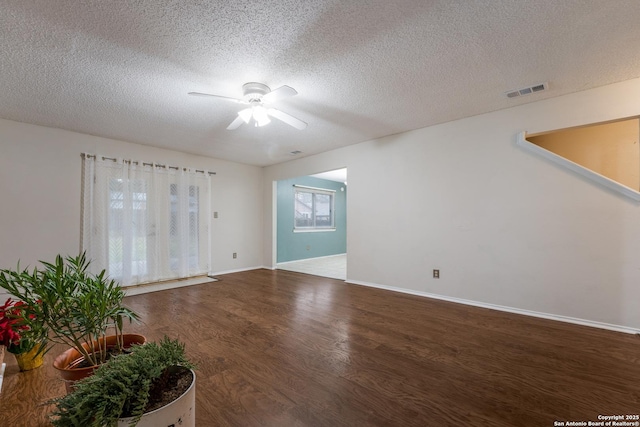 spare room featuring hardwood / wood-style flooring, ceiling fan, and a textured ceiling