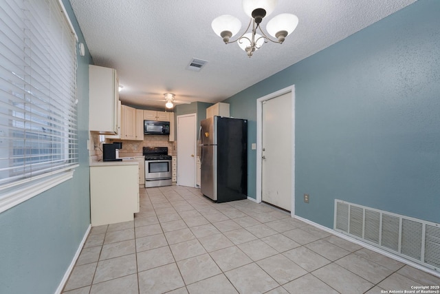 kitchen with stainless steel appliances, tasteful backsplash, white cabinets, a textured ceiling, and light tile patterned floors