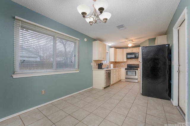 kitchen with appliances with stainless steel finishes, tasteful backsplash, ceiling fan with notable chandelier, a textured ceiling, and light tile patterned flooring