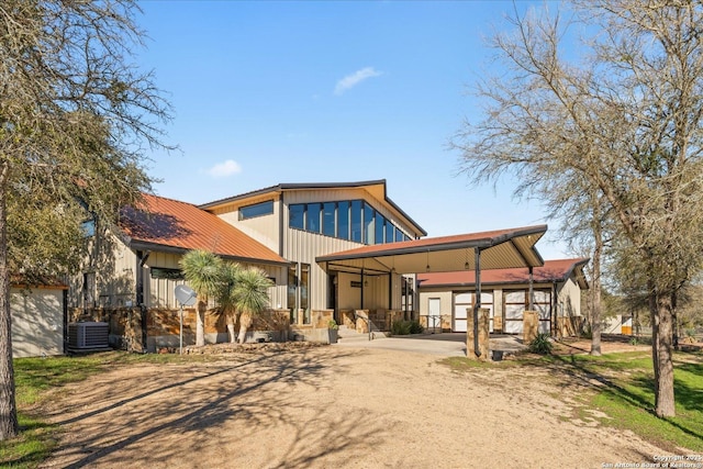 exterior space with central AC unit and a carport