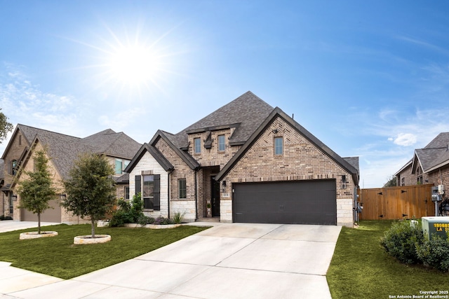 view of front of property with a front yard and a garage