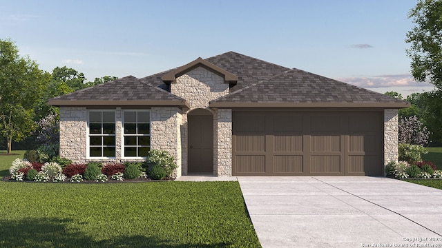 view of front of home featuring a front yard and a garage