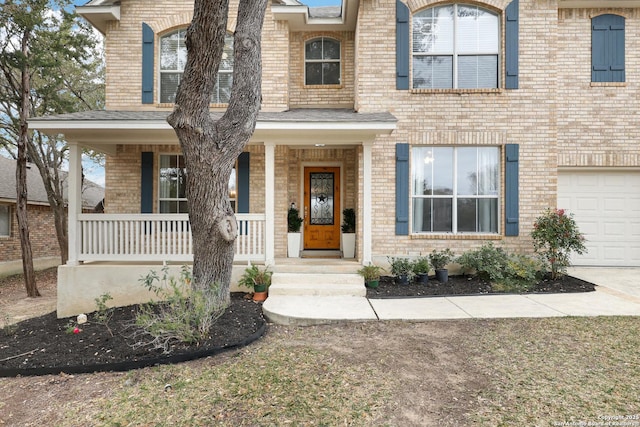 view of front of property with covered porch and a garage