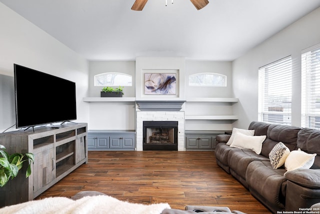 living room featuring a fireplace, ceiling fan, and dark hardwood / wood-style flooring