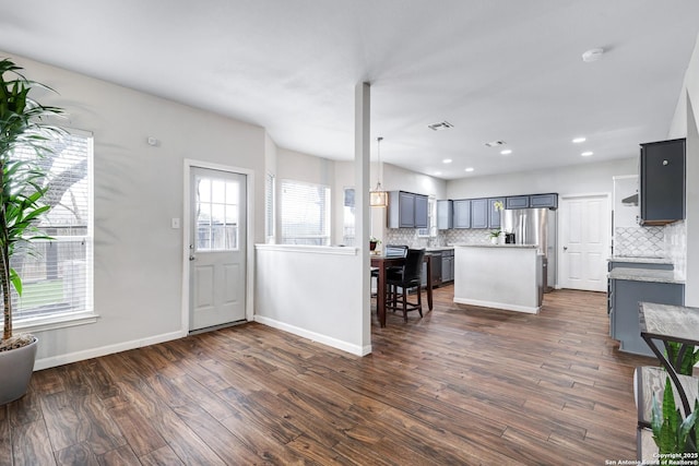 entrance foyer with a healthy amount of sunlight and dark hardwood / wood-style floors