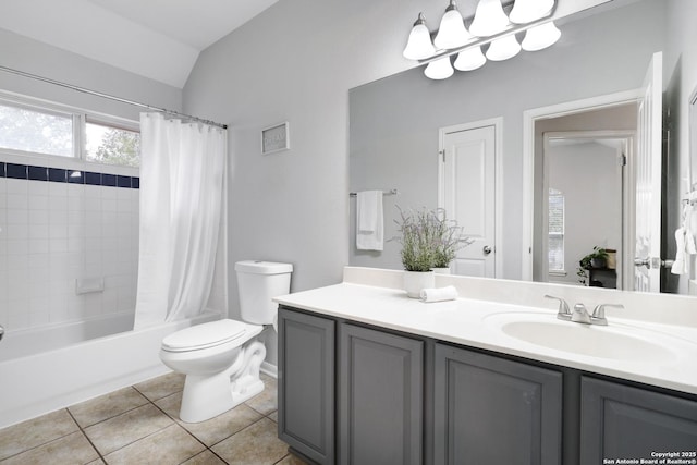 full bathroom with toilet, vanity, tile patterned floors, and vaulted ceiling