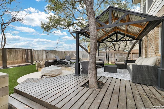 deck featuring a gazebo, ceiling fan, and an outdoor hangout area